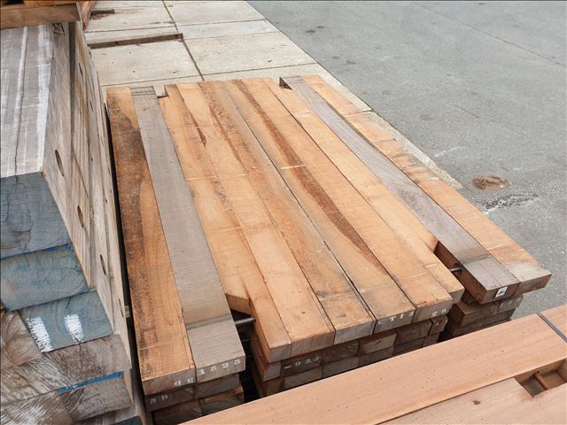 Neatly stacked bespoke 2m x 3m ekki timber mats for temporary roadways or stabilisation platforms.